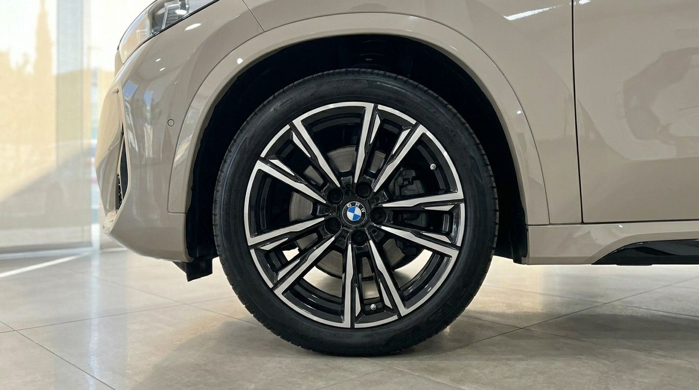 The gloss beige BMW X3 2.0 Diesel's front wheel with multi-spoke rim is visible in Alicante.