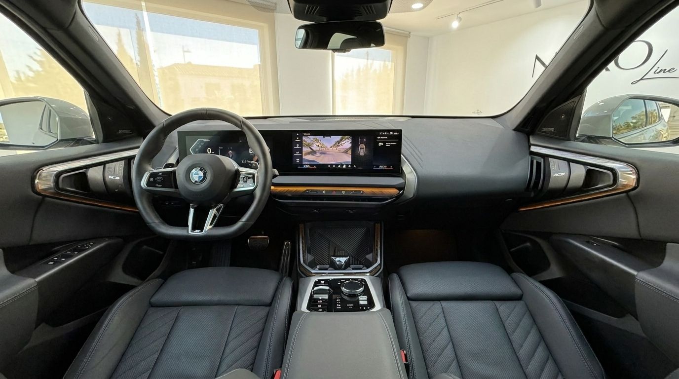 The luxurious interior of the BMW X3 2.0 Diesel in Alicante, featuring the steering wheel, dashboard, and central display.
