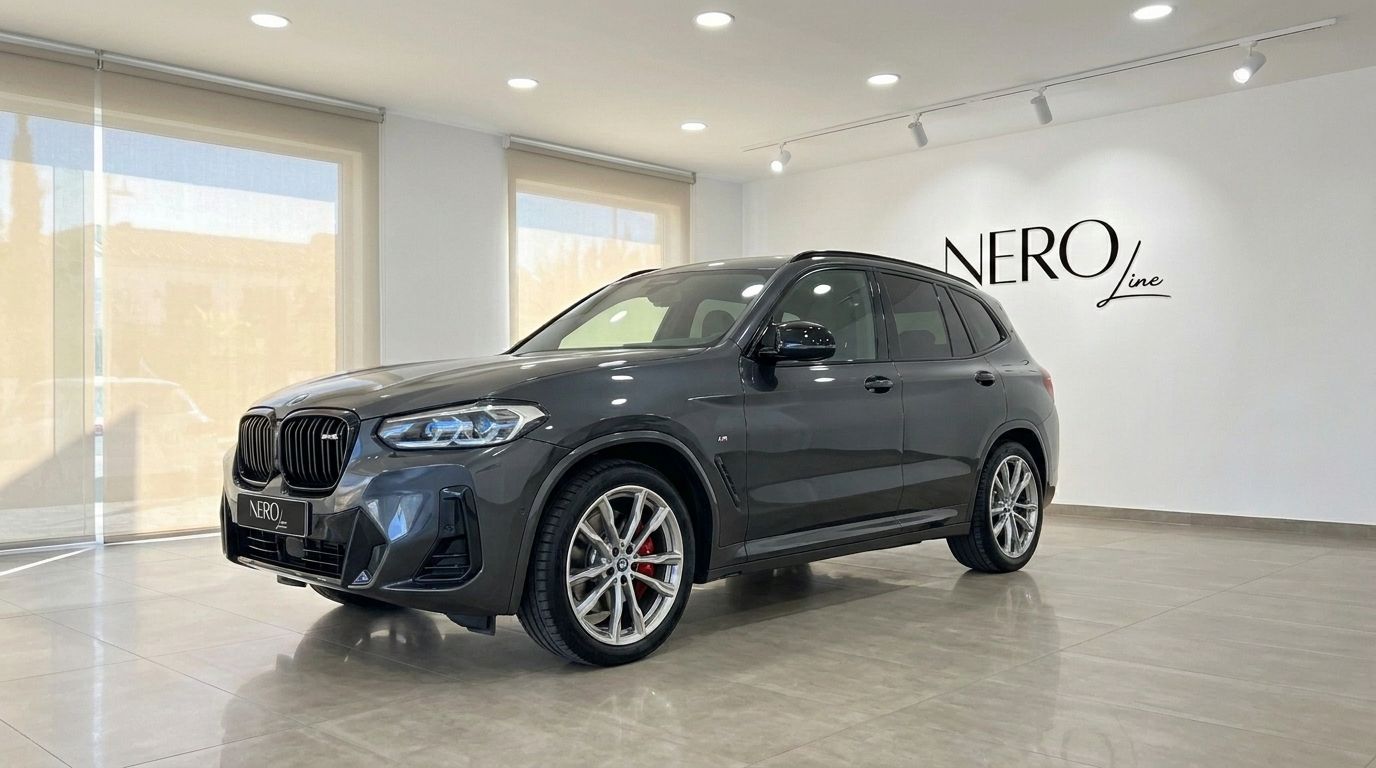 The dark grey BMW X3 M50D luxury performance SUV is displayed from a front three-quarter angle in a showroom in Alicante, Spain.