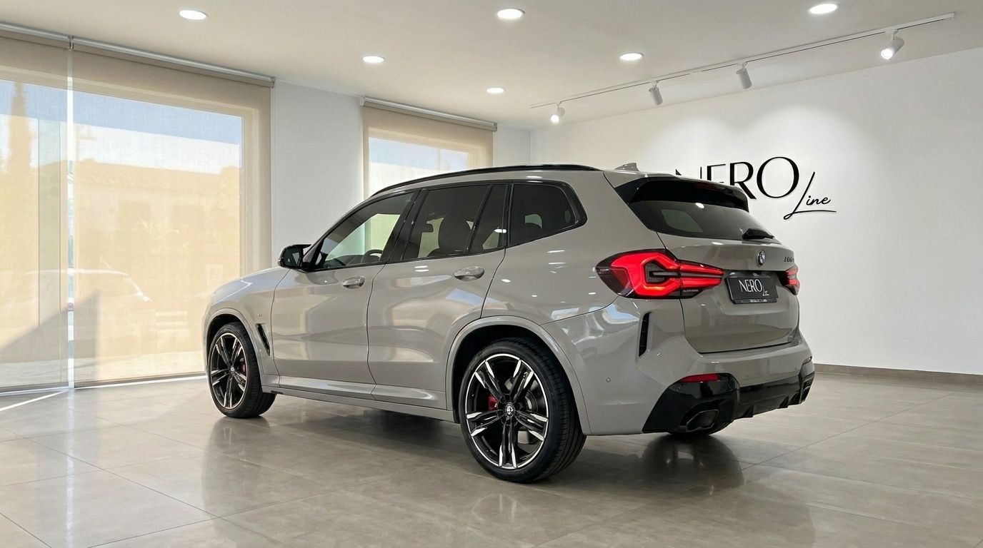 The Gloss Dune Grey 2025 BMW X3 M50i xDrive is showcased from a rear three-quarter angle in a Marbella showroom.