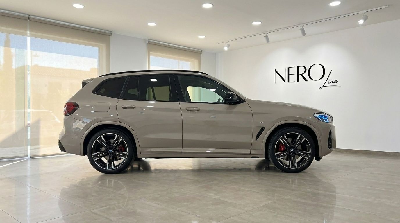 The 2025 BMW X3 M50i xDrive in Gloss Dune Grey, viewed from the side in a Marbella showroom.