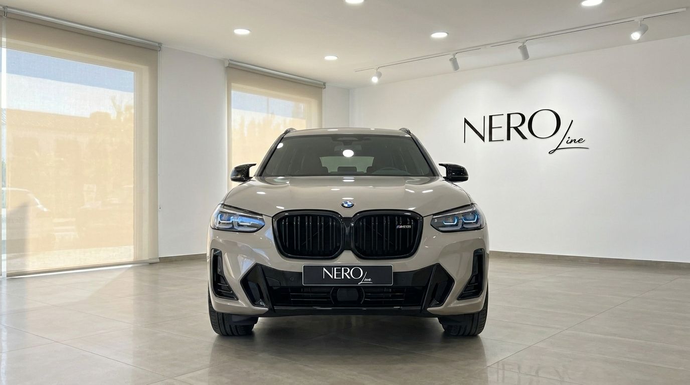 The 2025 BMW X3 M50i xDrive in Gloss Dune Grey, showcasing its powerful front grille and headlights in a Marbella showroom.