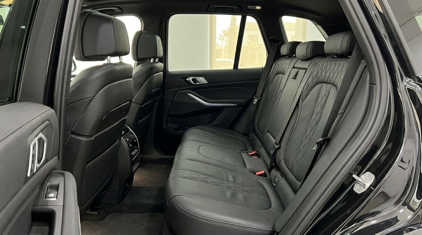 The luxurious black leather rear seats of the BMW X5 xDrive45e, showcasing ample passenger space in Alicante.