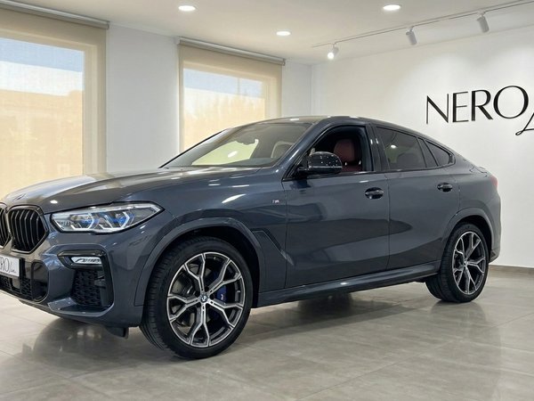 BMW X6 — Luxury SUV in Alicante Showroom A dark grey 2020 BMW X6 luxury SUV is showcased from a front three-quarter view inside a bright NEROline showroom in Alicante.