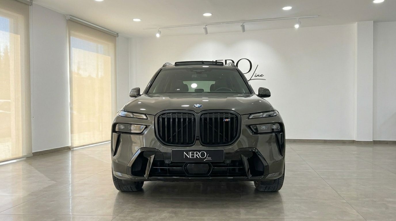 The luxurious 2025 BMW X7 is showcased from a direct front view inside a modern showroom in Alicante.