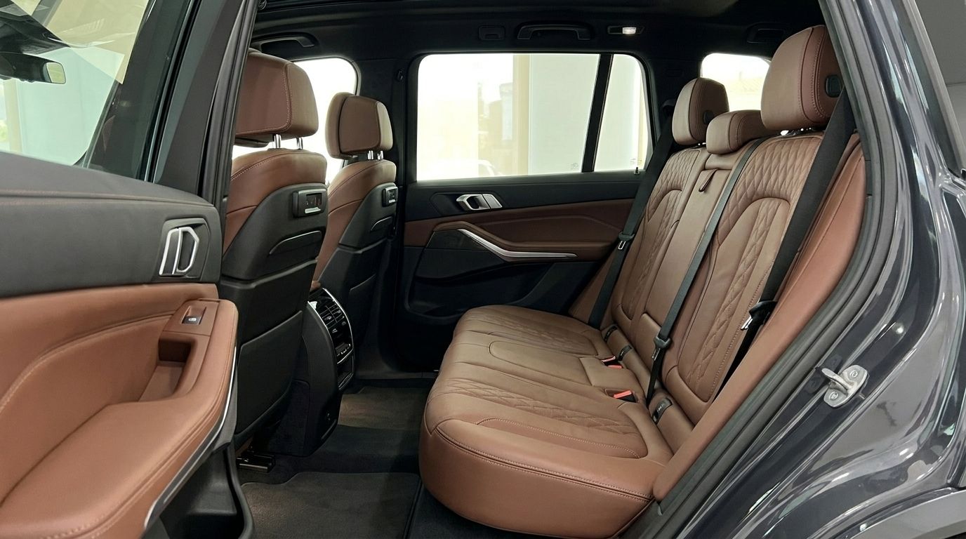 The luxurious brown leather rear seats and matching door panel of the BMW X7, showcasing its refined interior in Alicante.