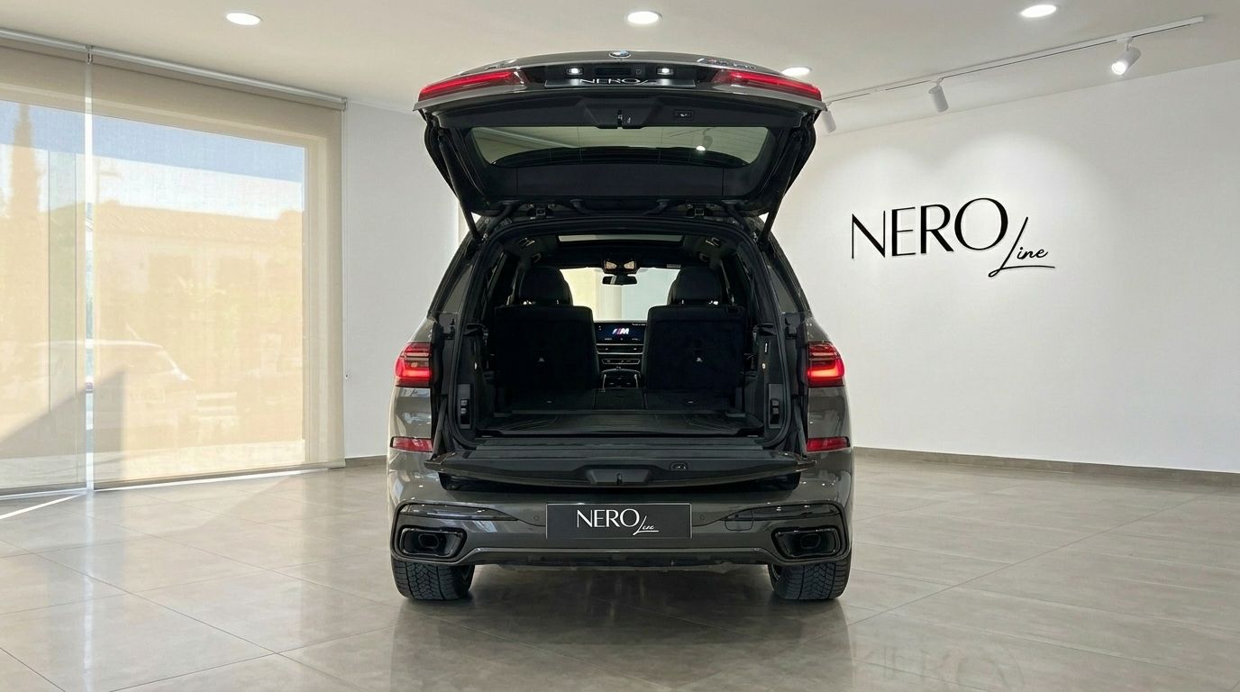 The BMW X7's spacious rear trunk is open, showcasing its cargo capacity and luxurious interior in Alicante.