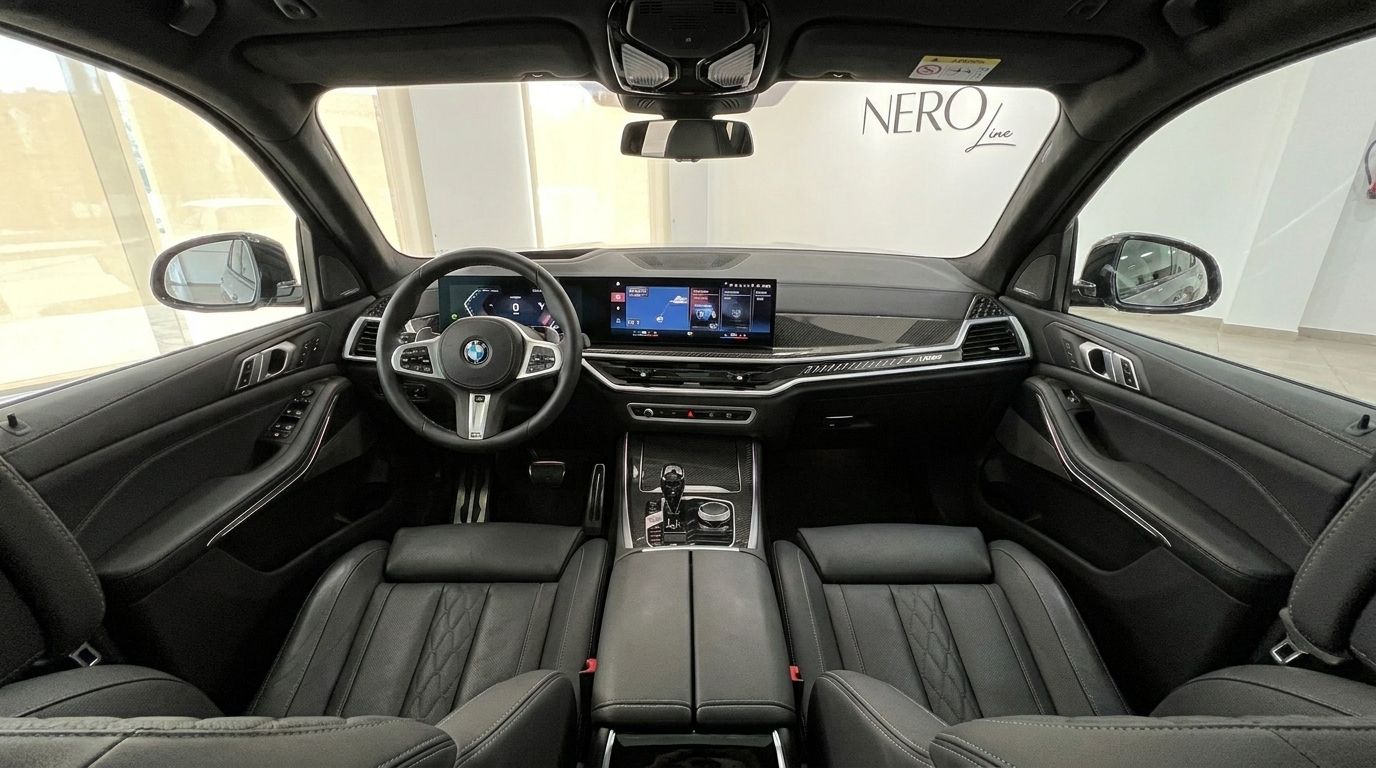The luxurious interior of the BMW X7 xDrive M Sport, featuring its dashboard, steering wheel, and front seats in Marbella.