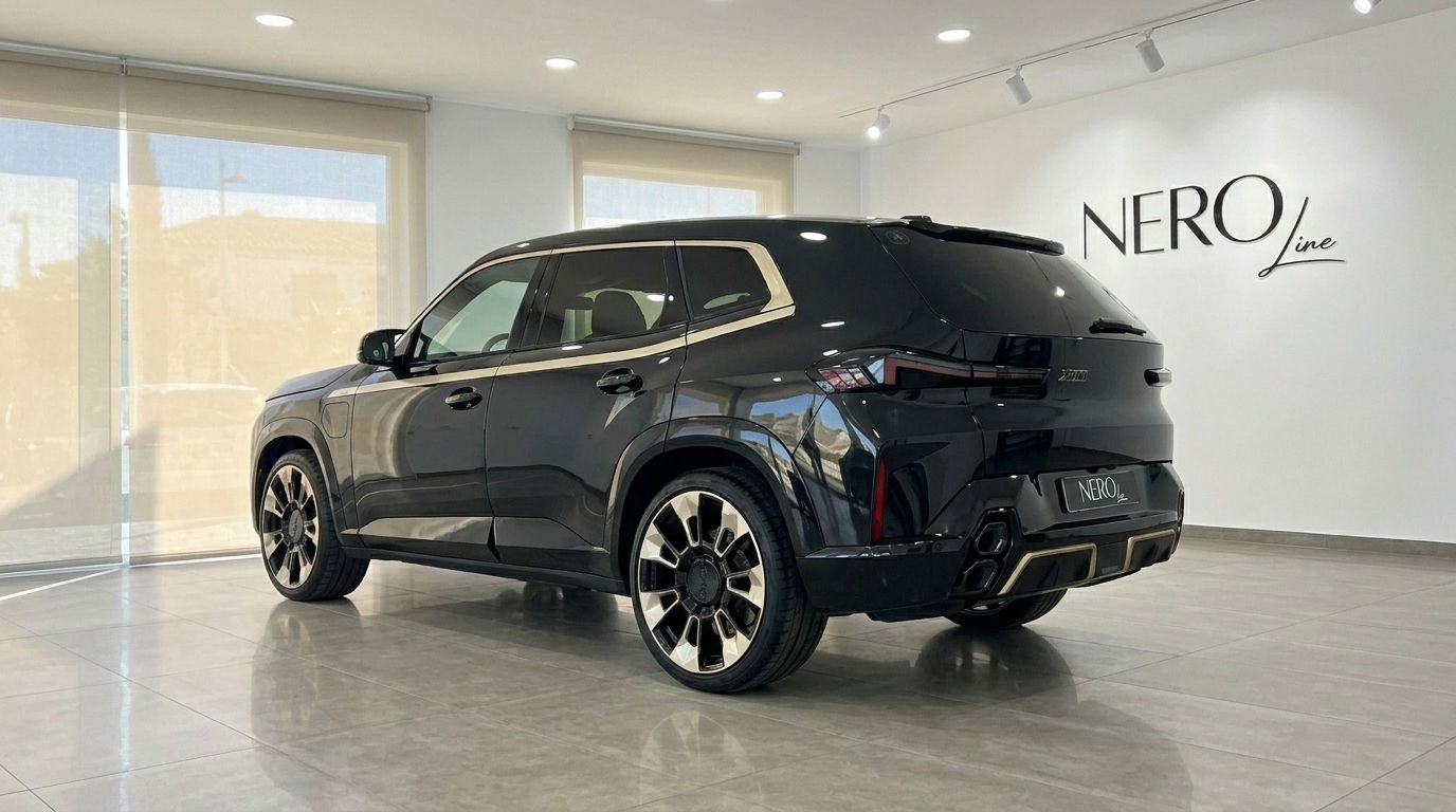 The Gloss Black 2025 BMW XM, with its distinctive gold accents and rear design, is parked in a showroom in Alicante.