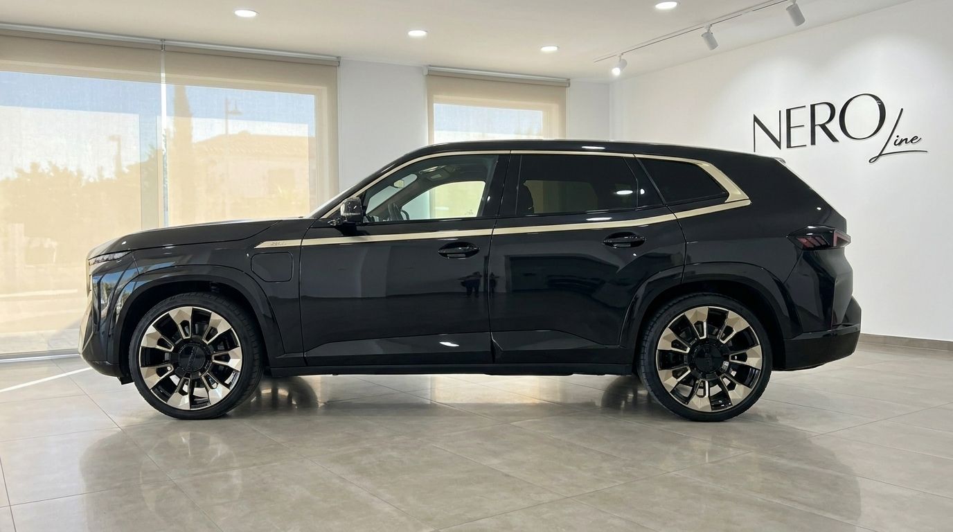 The Gloss Black 2025 BMW XM performance SUV is showcased in a side profile view at a showroom in Alicante.