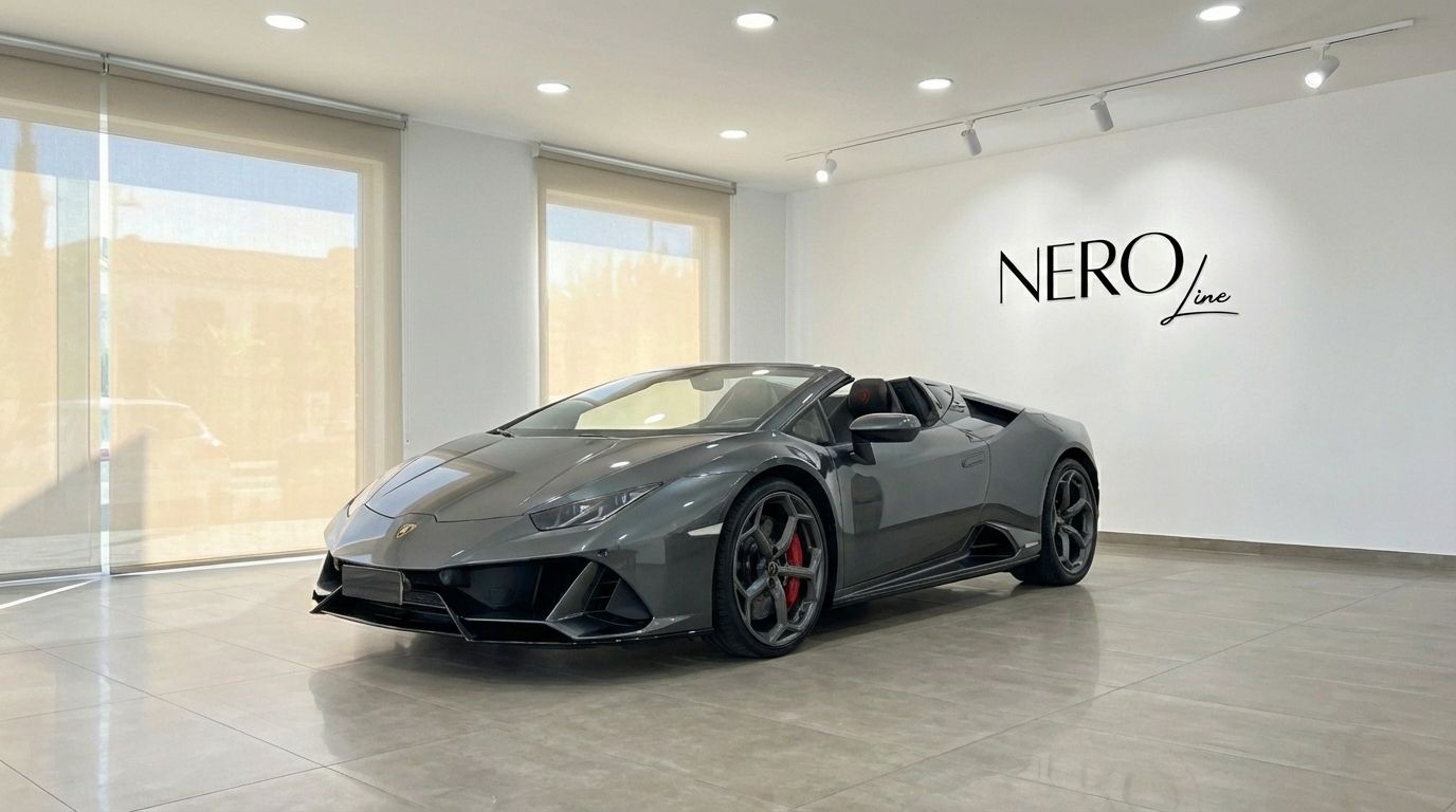 A metallic grey Lamborghini Huracan Evo Spyder convertible is parked in a modern showroom with the NEROline logo in Barcelona.