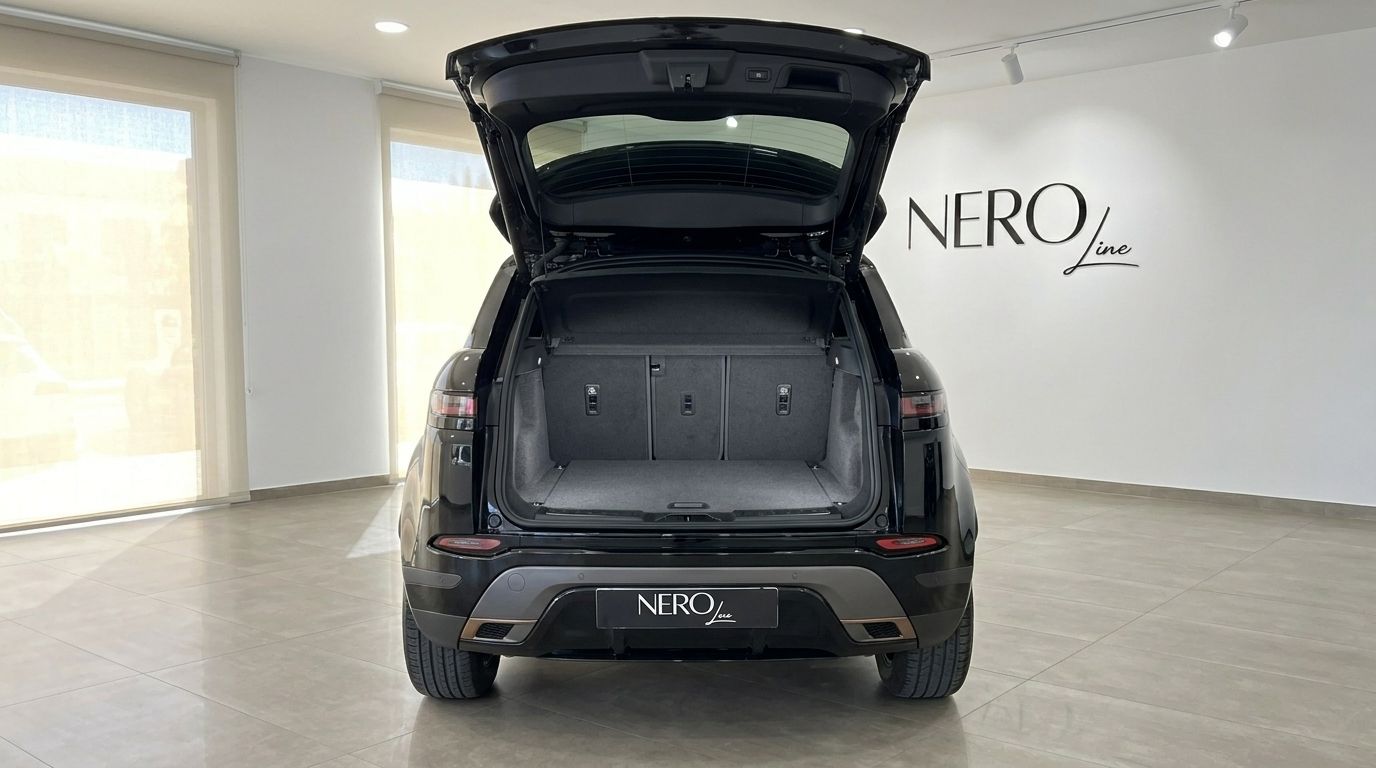 The rear view of the black Land Rover Range Rover Evoque R-Dynamic (2nd) with its boot open, showcasing the spacious trunk in Alicante.
