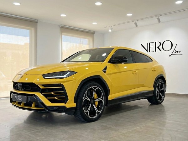 Lamborghini Urus — Glossy Yellow in Showroom The glossy yellow Lamborghini Urus, a performance SUV, is showcased in a showroom with the Nero Line logo in Marbella.