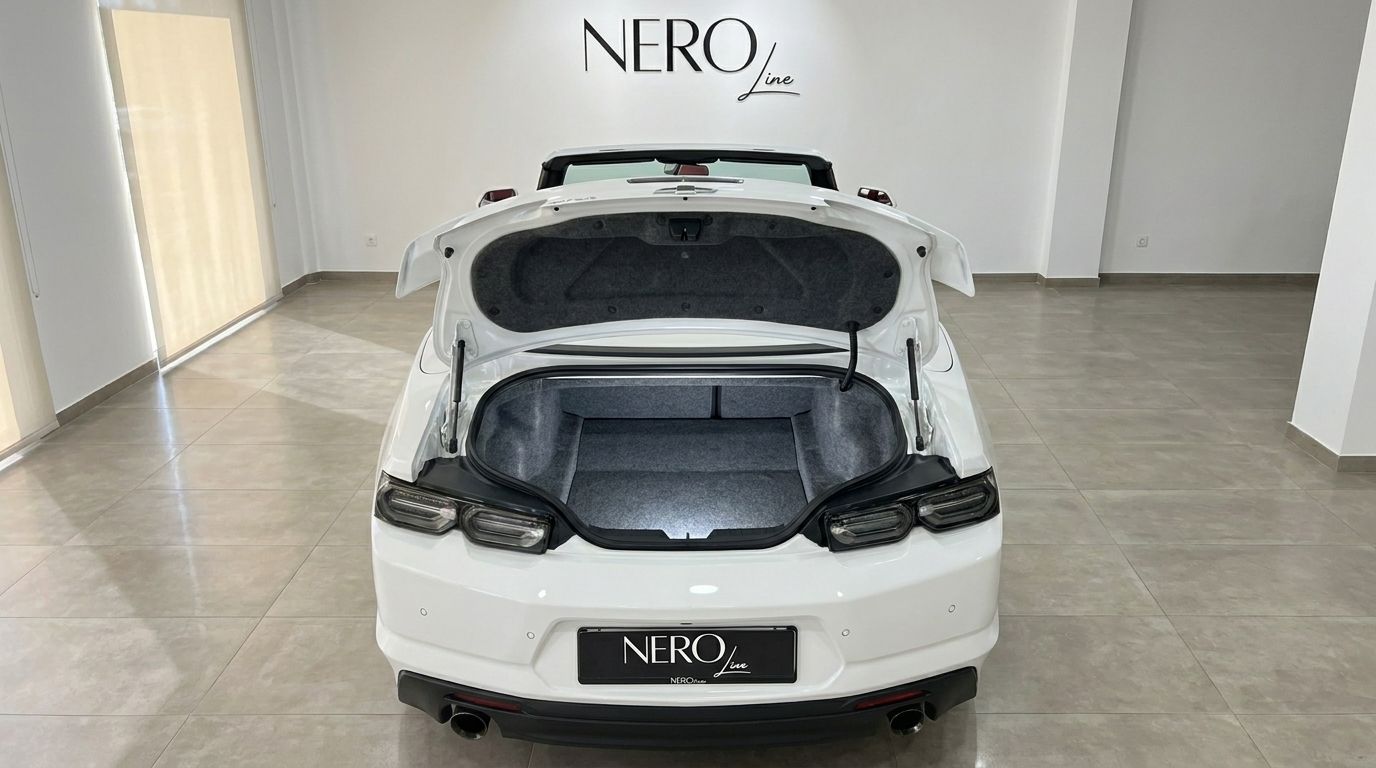 The rear view of the white Chevrolet Camaro Cabrio 3.6 in Alicante, showcasing its open trunk and sleek design.