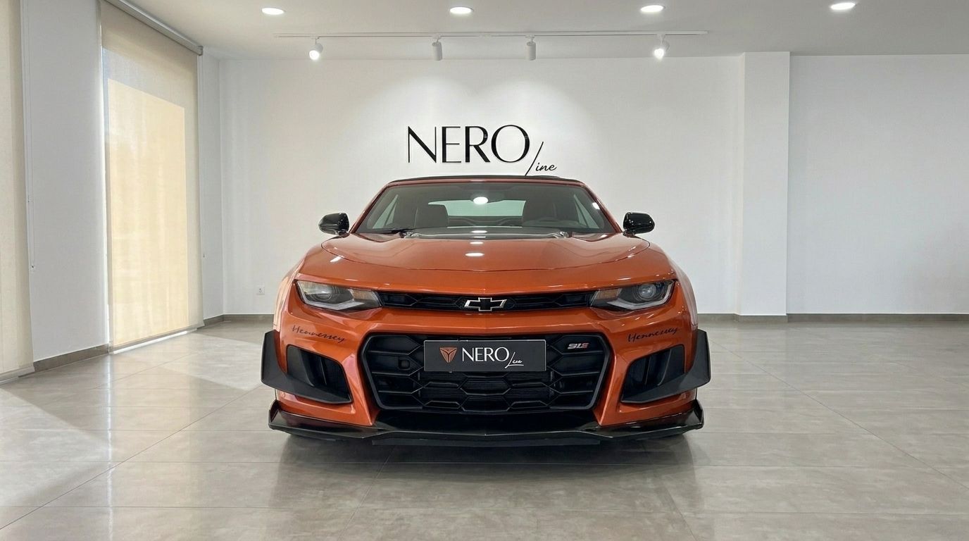 Front view of the Gloss Metallic Orange Chevrolet Camaro Cabriolet 6.2, parked in a showroom in Alicante, Spain.