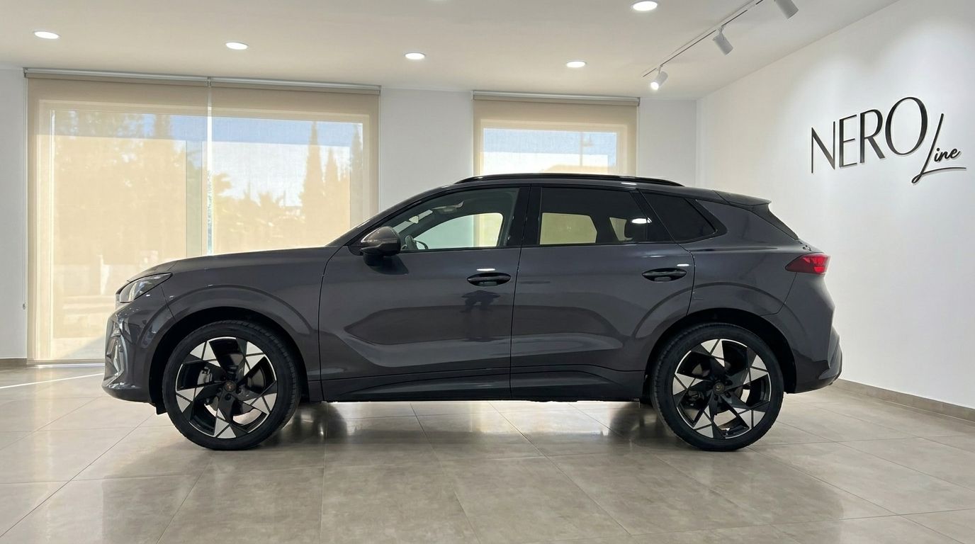 Der 2026 Cupra Terramar in glänzendem Dunkelgrau Metallic wird von der Seite in einem modernen Showroom in Alicante präsentiert.