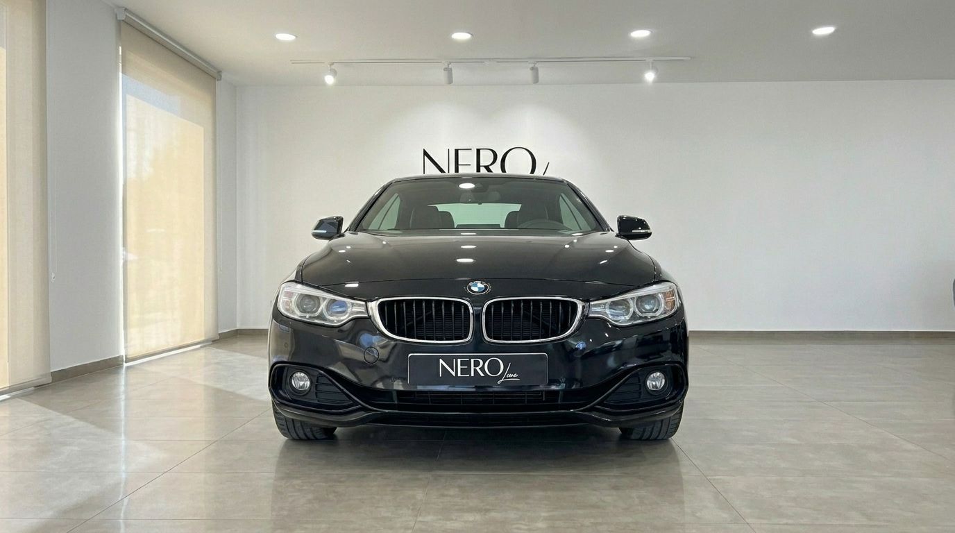 Black BMW 420 Cabriolet front view in a bright showroom with the NERO logo on the wall in Alicante.