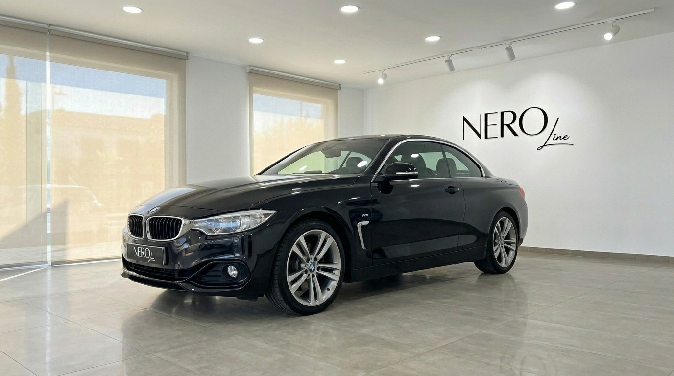 BMW 420 Cabriolet — Showroom view in Alicante The black BMW 420 Cabriolet, with its hardtop up, is showcased from a front-three-quarter angle in a modern Alicante showroom.