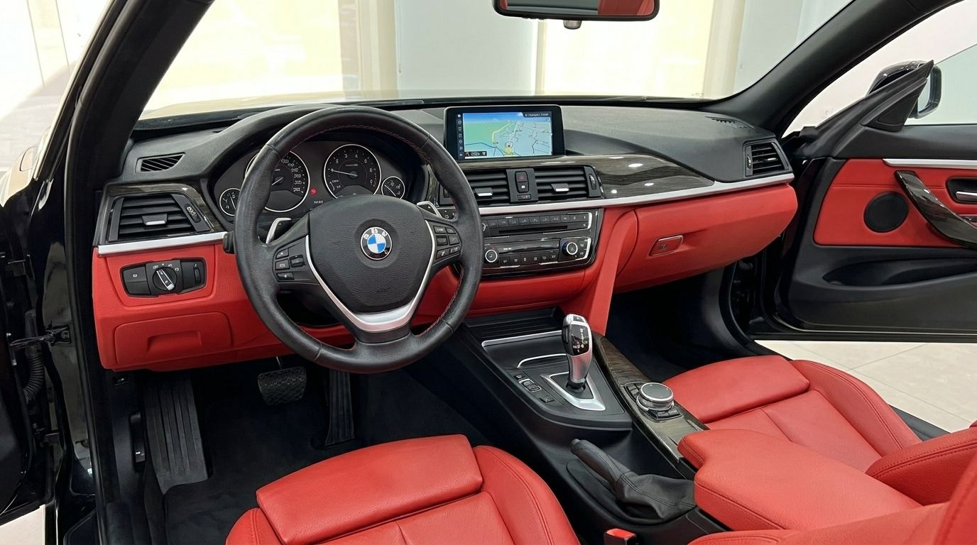 BMW 420 Cabriolet's luxurious interior in Alicante, with dashboard, steering wheel, gear shifter, and vibrant red leather seats.