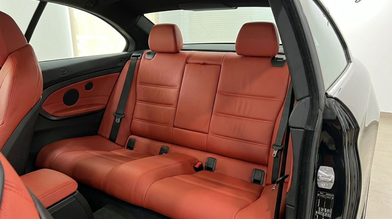 The luxurious red leather rear seats and interior details of the BMW 420 Cabriolet, available for rent in Alicante.