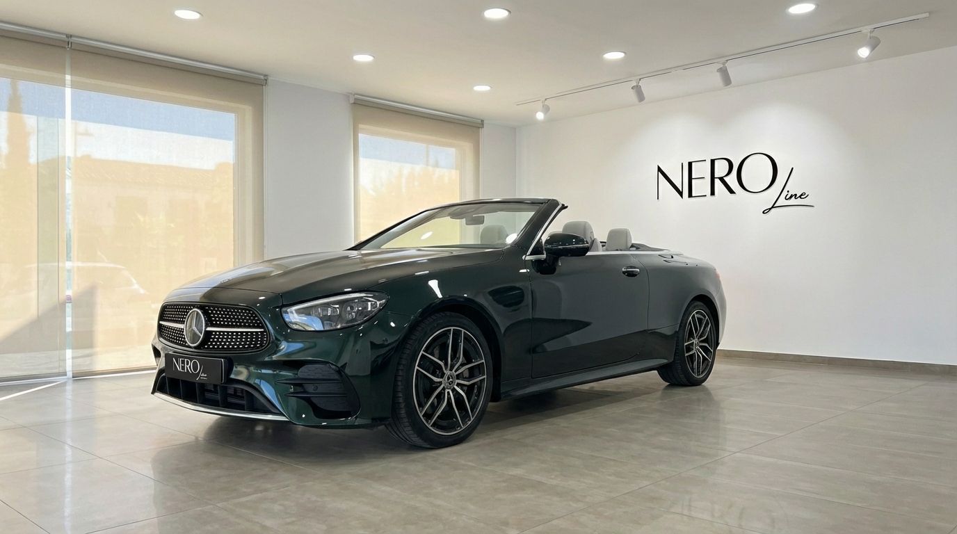 Dark green Mercedes-Benz E300 Cabrio, convertible top down, showcased in a modern showroom in Alicante.