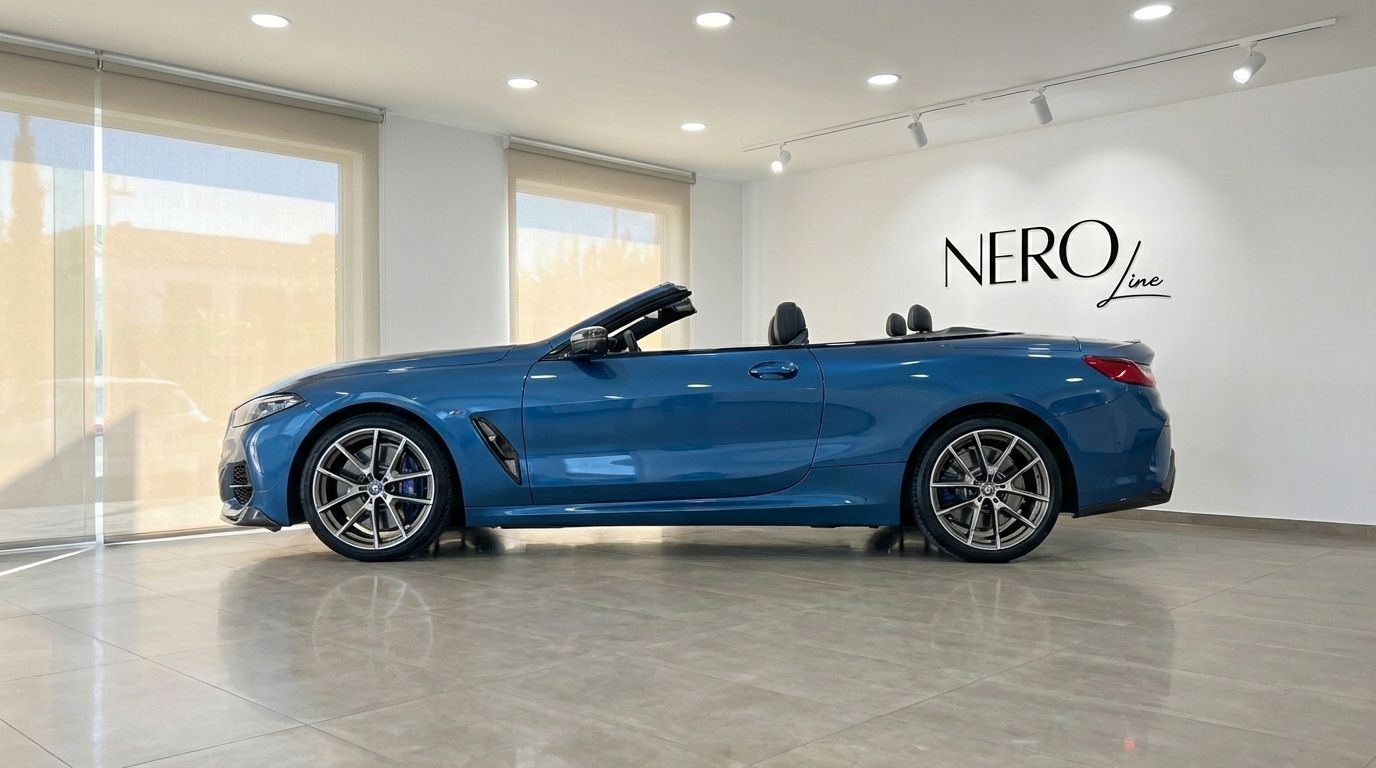 The sky blue BMW M850i Carbon Core Edition convertible is showcased from its side profile in a bright Alicante showroom.