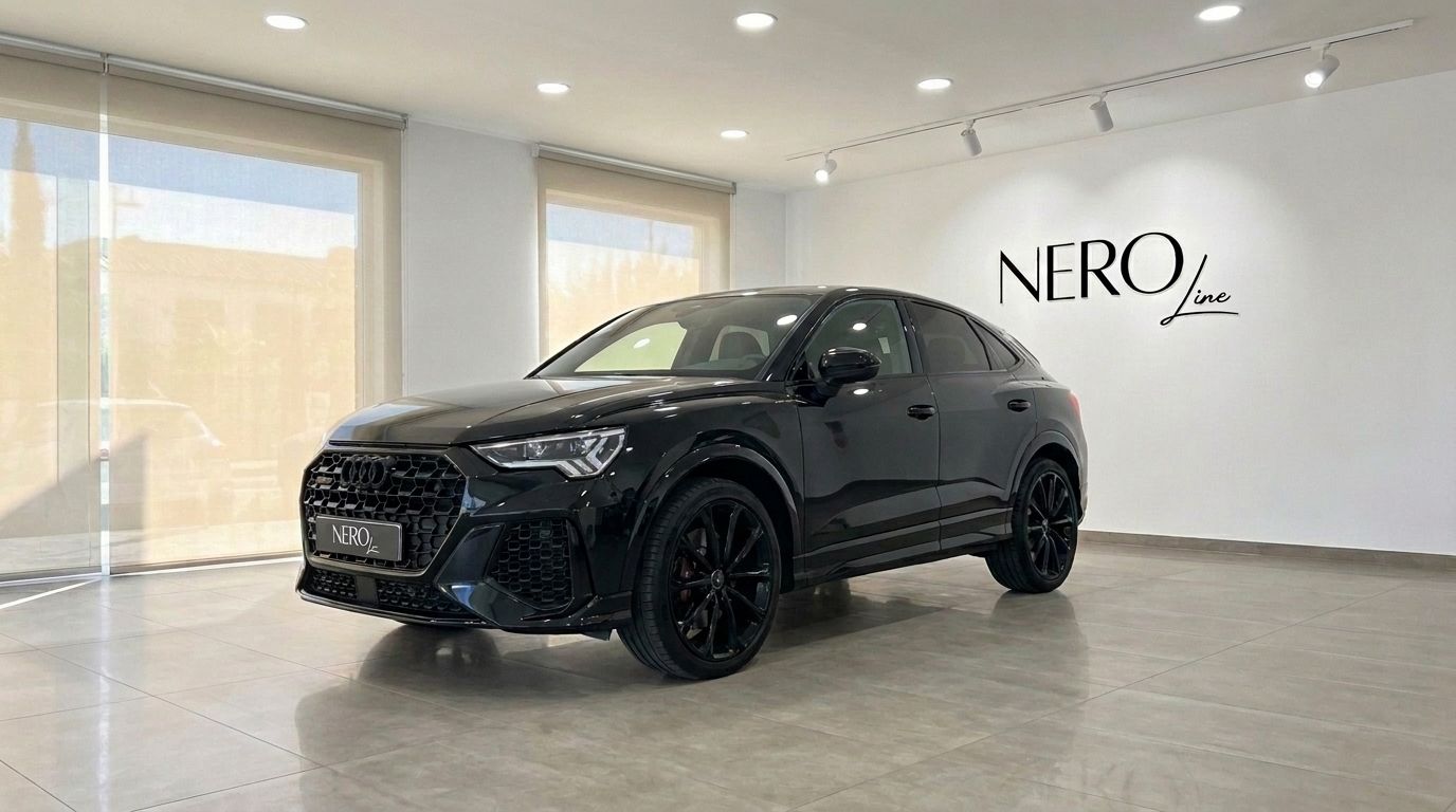 A sleek black Audi RS Q3 is prominently displayed in a modern showroom in Ibiza, showcasing its dynamic front-three-quarter view.