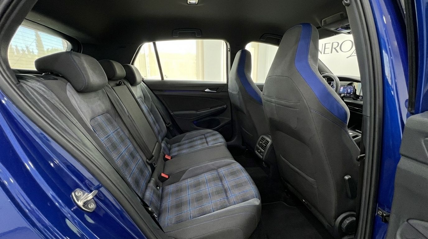 The rear interior of the 2023 Volkswagen Golf R in Marbella, featuring blue plaid seats and the back of the front sport seats.