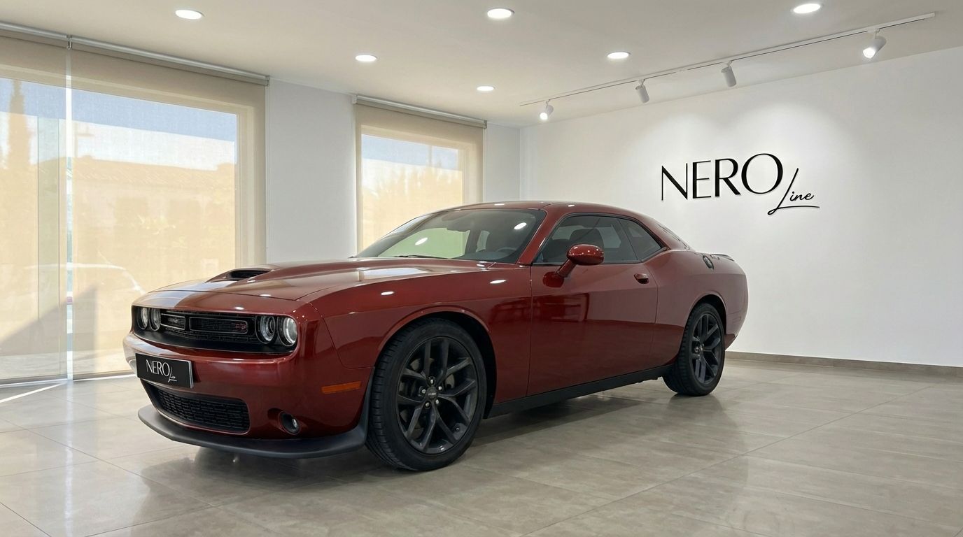 The burnt orange 2023 Dodge Challenger V6 is showcased from a front three-quarter angle in a bright Alicante showroom.