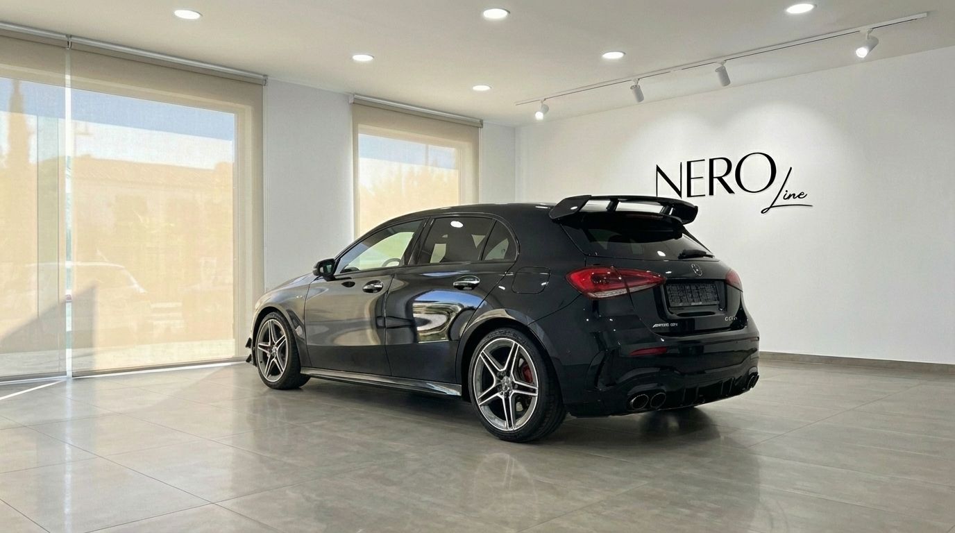 The black 2024 Mercedes-Benz A 45 S is shown from a rear three-quarter angle, parked in a brightly lit showroom in Alicante.