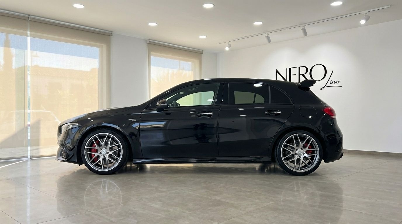 The sleek metallic black 2024 Mercedes-Benz A 45 S is shown in a side profile view inside a showroom in Alicante.