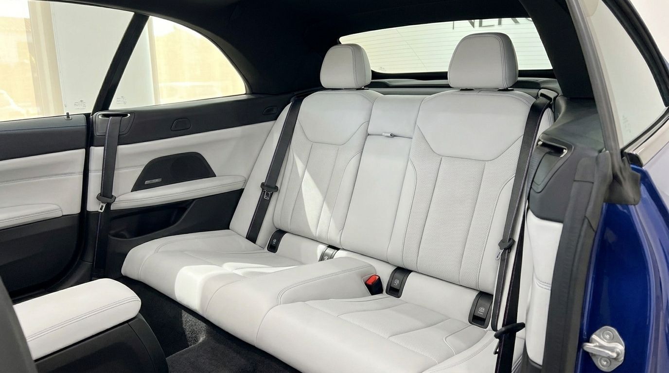 The luxurious light grey rear seats and interior of the 2025 BMW M4 Competition Convertible in Barcelona.