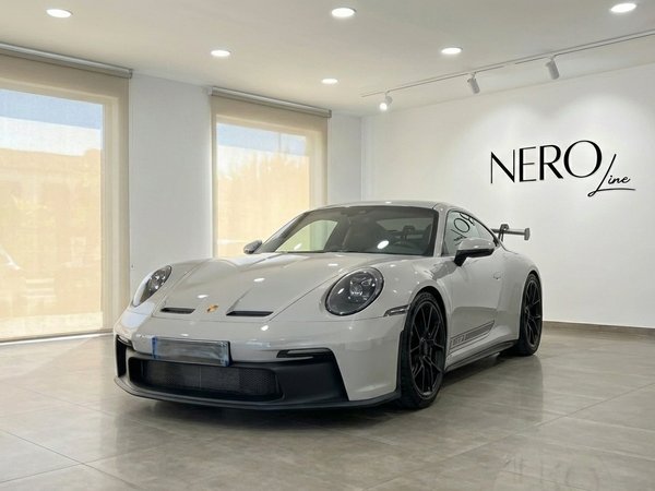 Porsche 911 GT3 992 — Showroom in Ibiza The white Porsche 911 GT3 992 is showcased from a front three-quarter angle in a modern showroom in Ibiza.