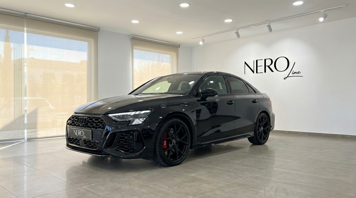 Audi RS3 Saloon — Front three-quarter view Marbella The sleek black 2022 Audi RS3 Saloon is showcased from a front three-quarter angle in a modern Marbella showroom.
