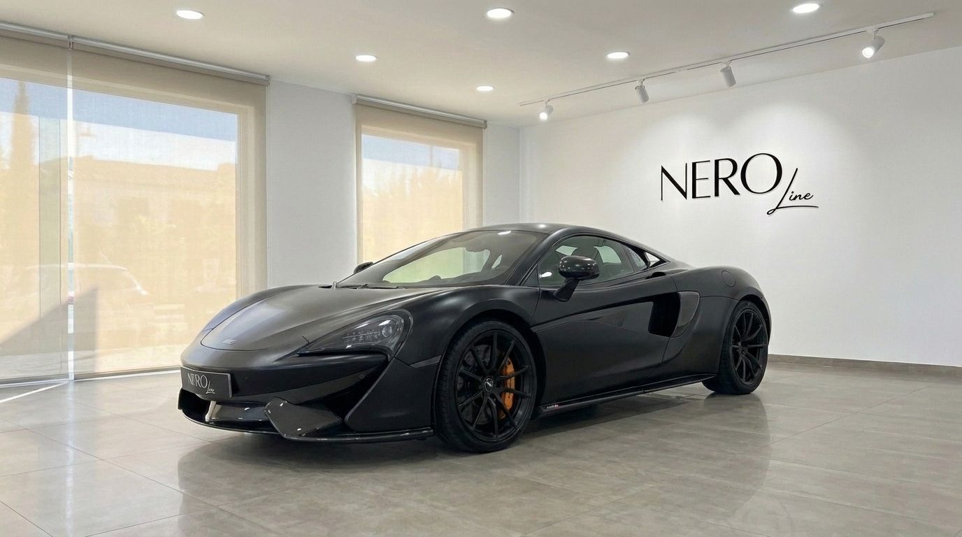 The matte black McLaren 570S supercar is showcased from a front three-quarter angle in a bright Marbella showroom.