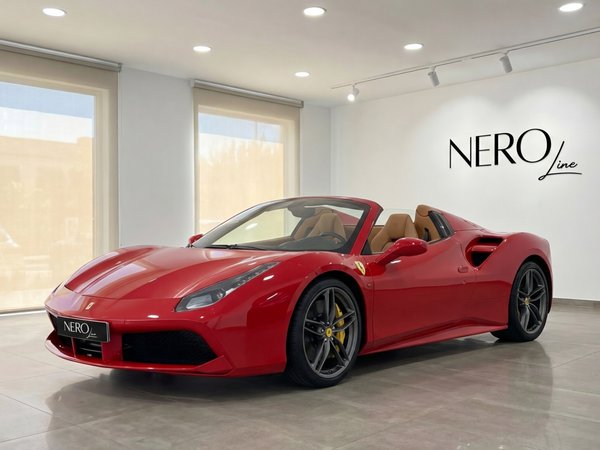 Ferrari 488 Spider — Showroom display in Mallorca The red Ferrari 488 Spider convertible is showcased in a modern showroom in Mallorca, featuring its open top and luxurious tan interior.