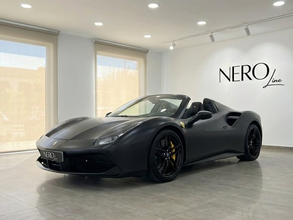 Ferrari 488 Spider — Matte Black Convertible The matte black Ferrari 488 Spider convertible is parked in a showroom in Valencia, showcasing its sleek design.