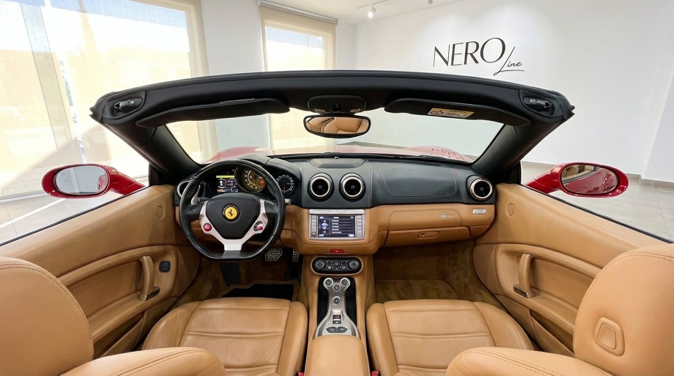 The luxurious tan leather interior and dashboard of the red Ferrari California convertible, showcasing the cockpit in Alicante.