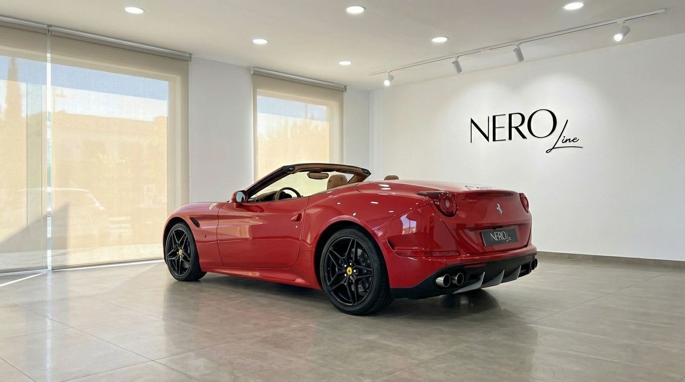 Red Ferrari California convertible, top down, shown from the rear quarter in a bright Alicante showroom.