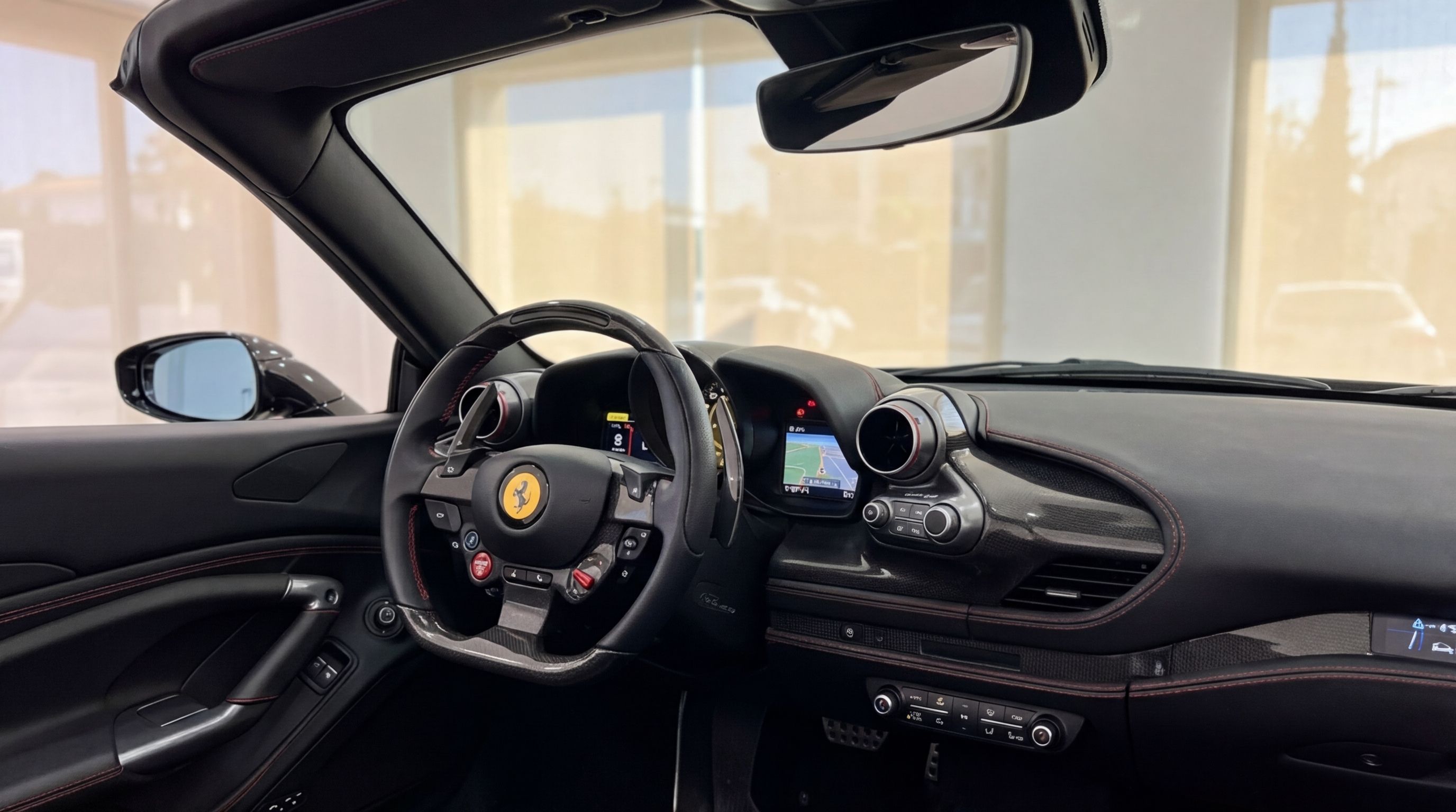 The luxurious cockpit of the black Ferrari F8 Spider in Ibiza, featuring a detailed view of the steering wheel, dashboard, and navigation screen.