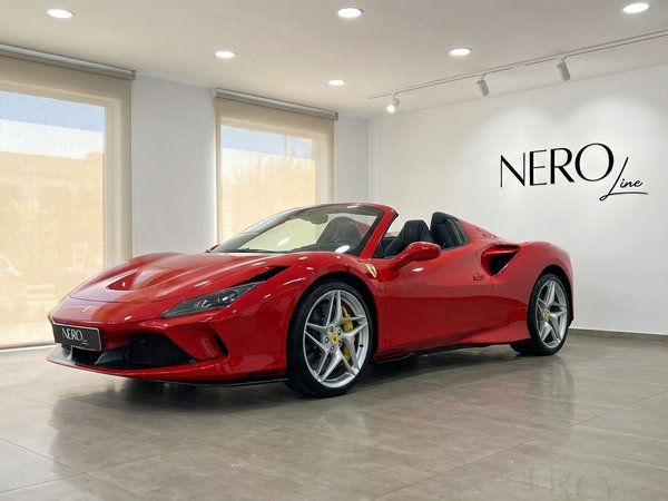 Ferrari F8 Spider — Exposición en showroom Madrid El Ferrari F8 Spider rojo, con la capota bajada, se exhibe en un concesionario en Madrid, mostrando su elegante diseño.