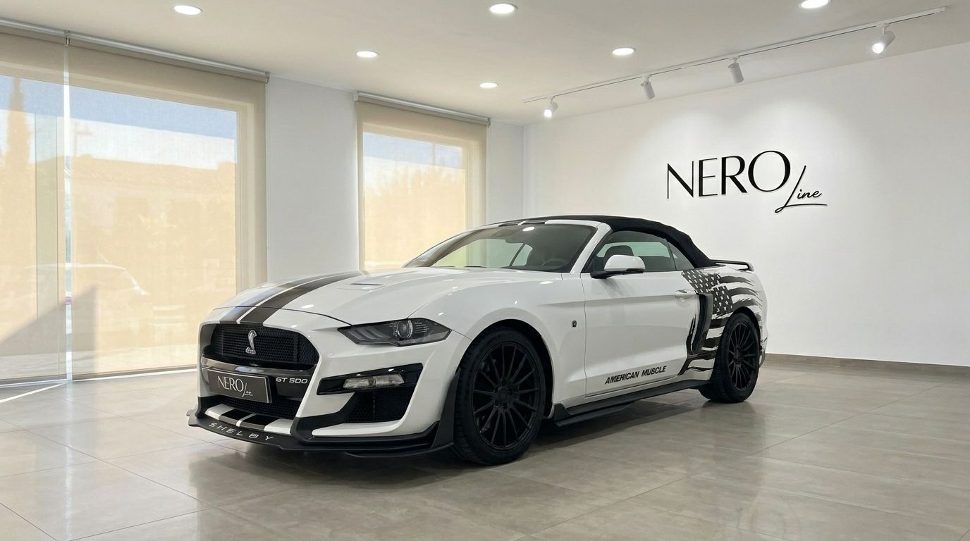 White Ford Mustang 2.3 EcoBoost Convertible with black stripes and soft top, Shelby GT500 style, displayed in a Benidorm showroom.