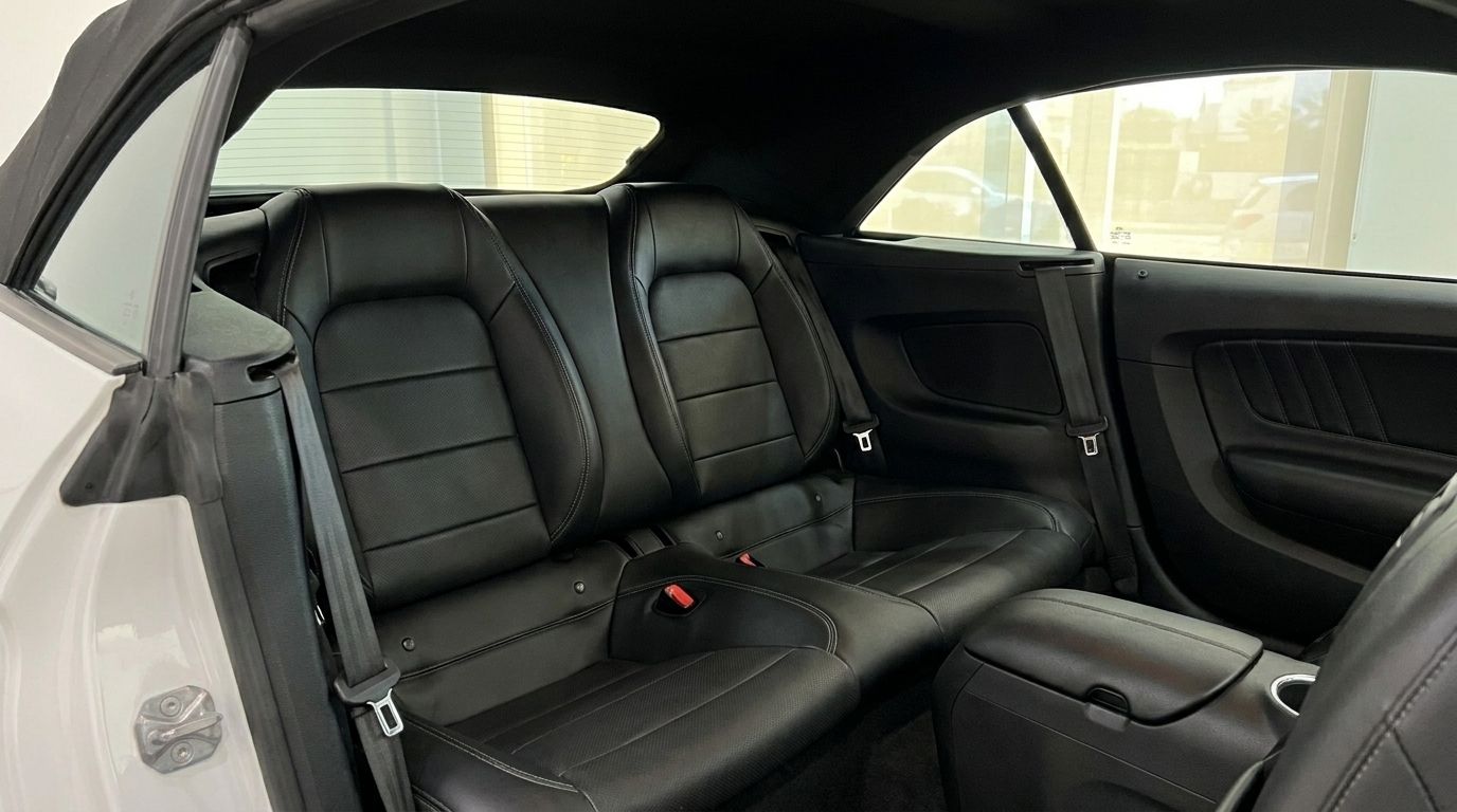 The rear black leather seats of the Ford Mustang 2.3 EcoBoost Convertible in Benidorm, showcasing the spacious interior.