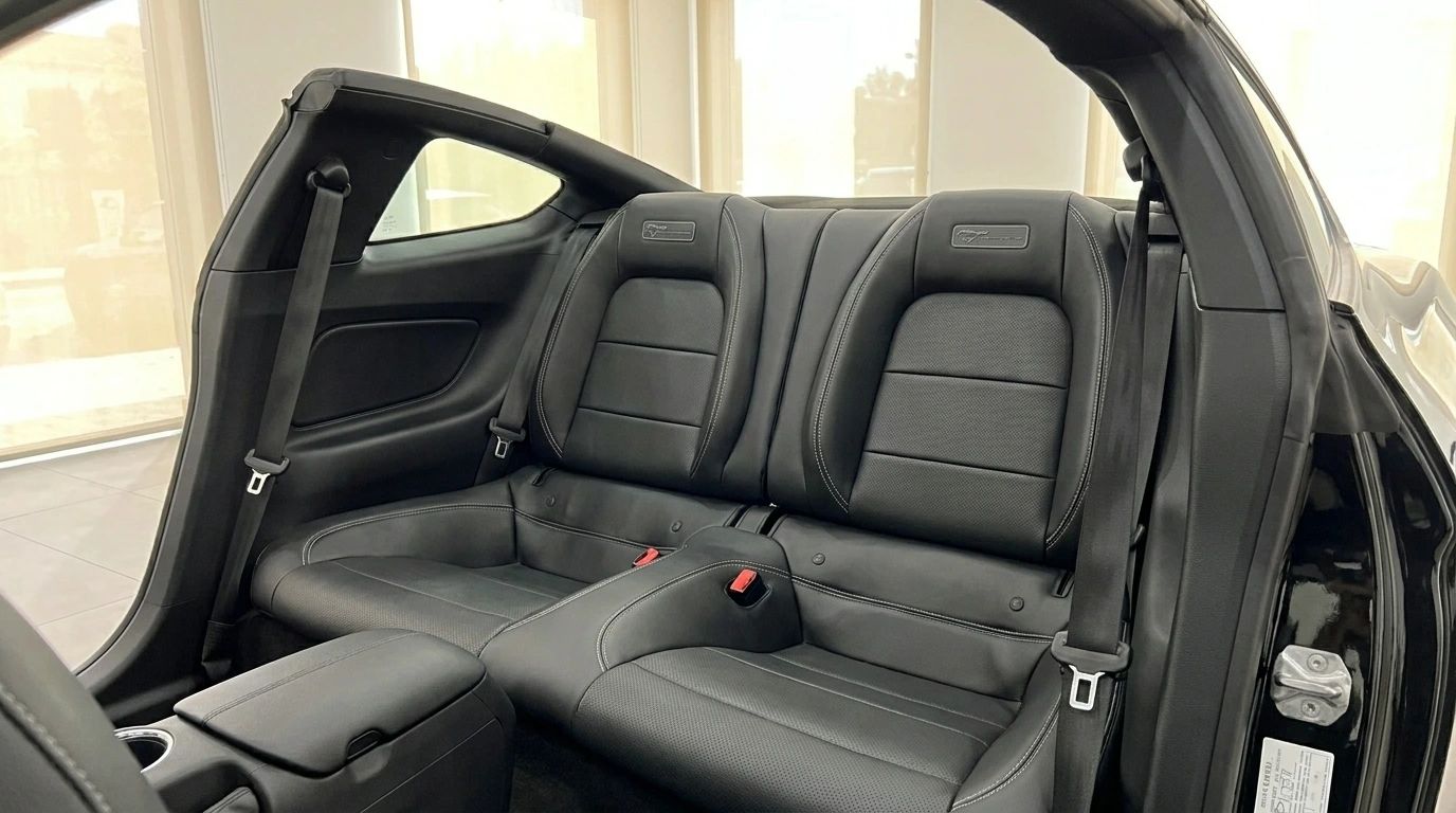 The luxurious black leather rear seats with white stitching are visible inside the Ford Mustang GT 5.0 in Alicante.