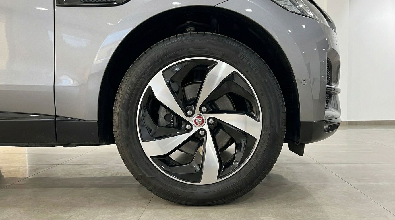 The 2022 Jaguar F-Pace's front wheel, showcasing its elegant black and silver alloy rim and grey bodywork, available in Alicante.