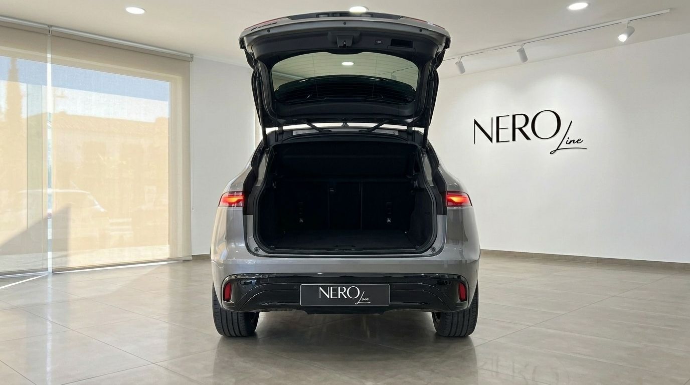 The 2022 Jaguar F-Pace in Alicante, showcasing its spacious open trunk from a rear view.