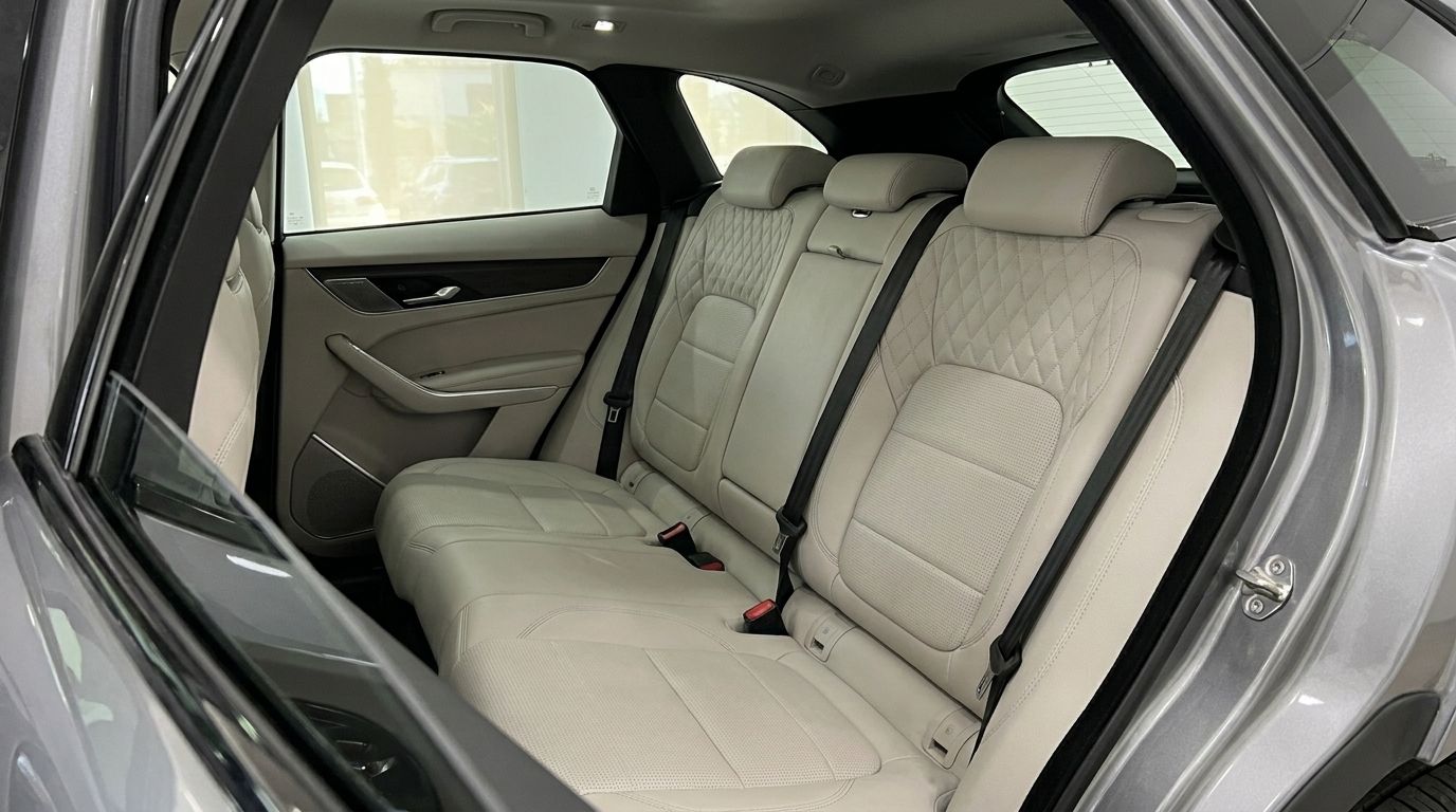 Jaguar F-Pace's luxurious rear passenger seats with light leather upholstery and diamond stitching in Alicante.