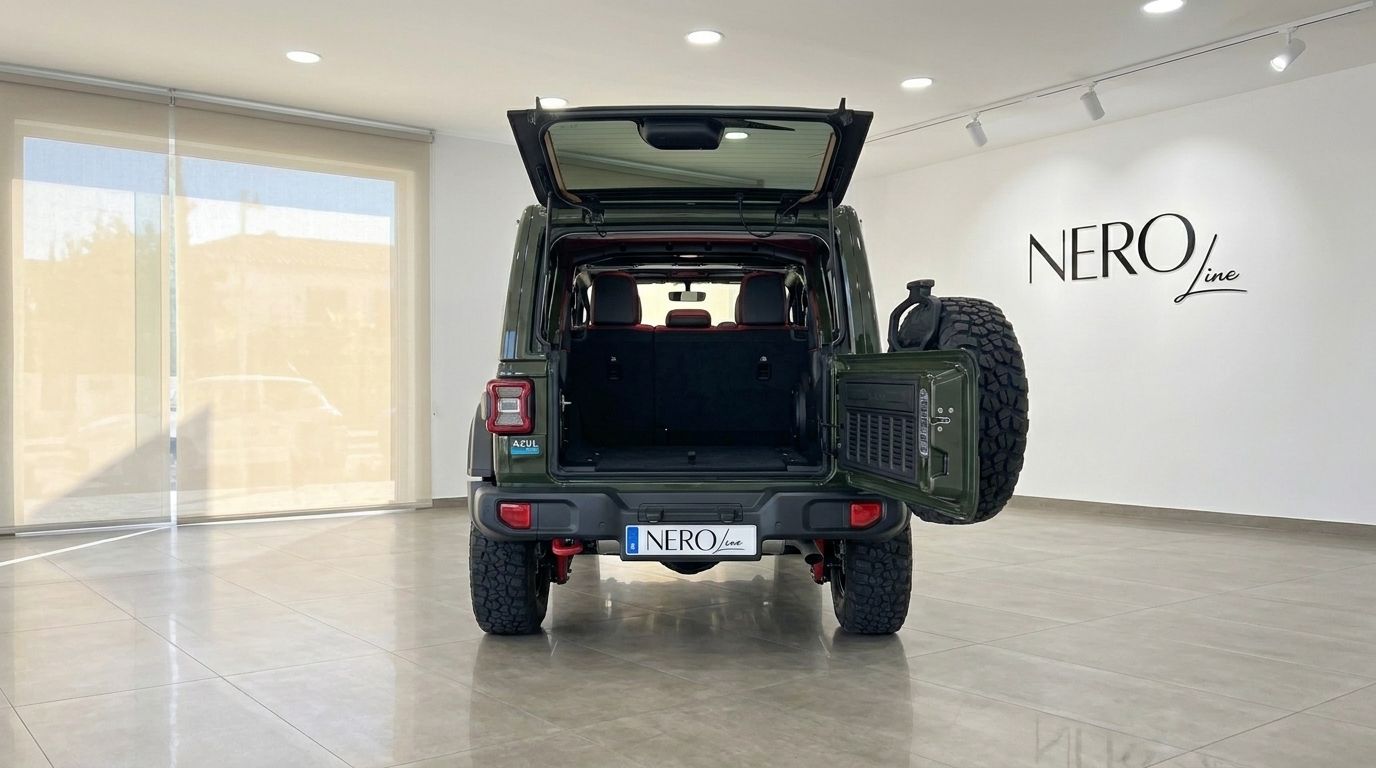 The rear view of the Jeep Wrangler Rubicon in Mallorca, featuring its open trunk and tailgate-mounted spare wheel.