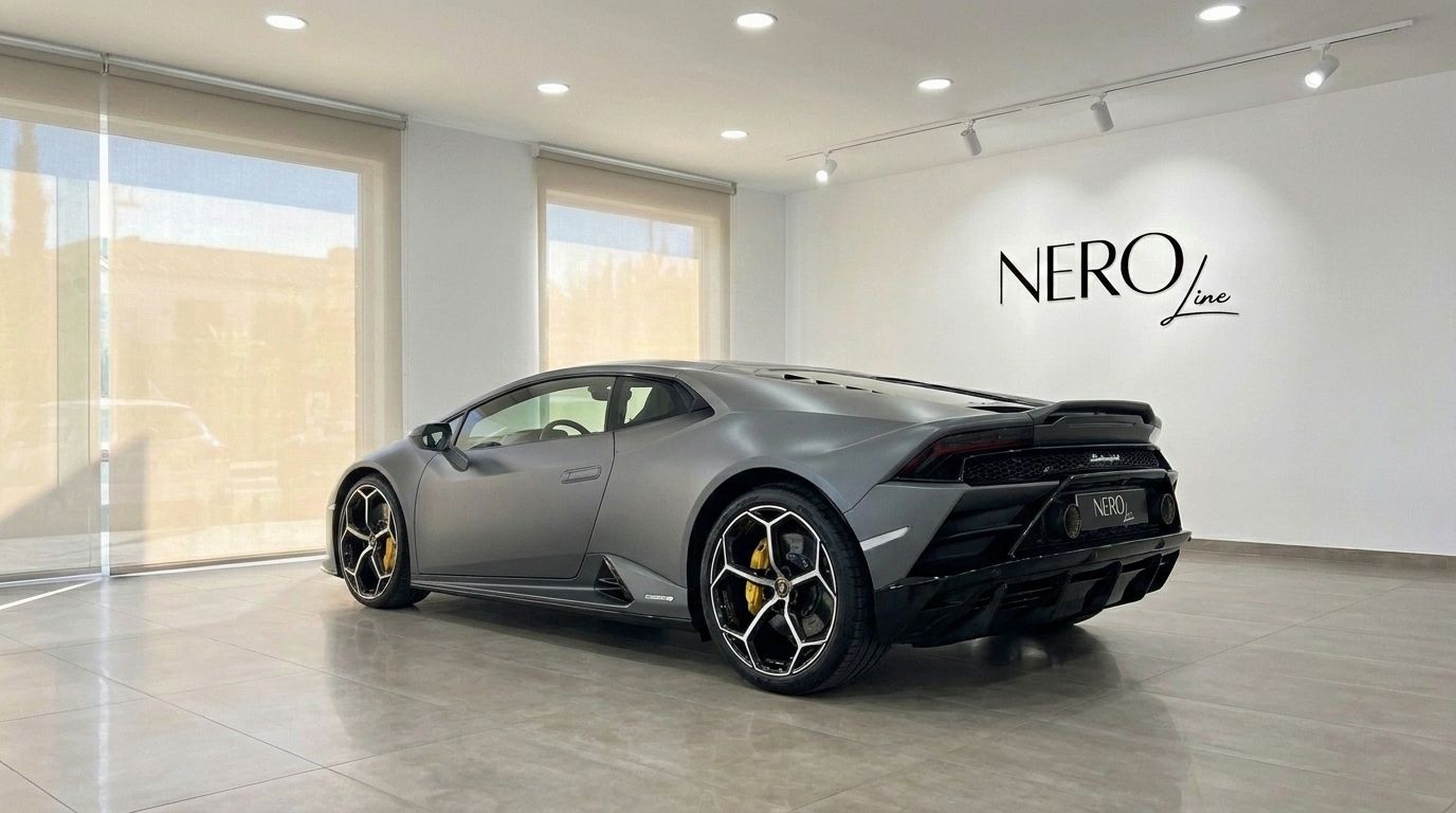 The matte grey Lamborghini Huracan EVO is shown from the rear three-quarter angle in a bright showroom in Mallorca.