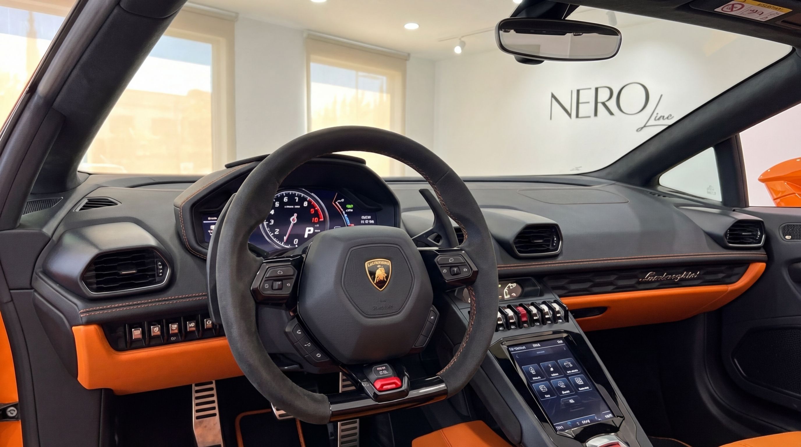 Lamborghini Huracan Evo Spyder cockpit in vibrant orange and black, showcasing the steering wheel and dashboard in Malaga.
